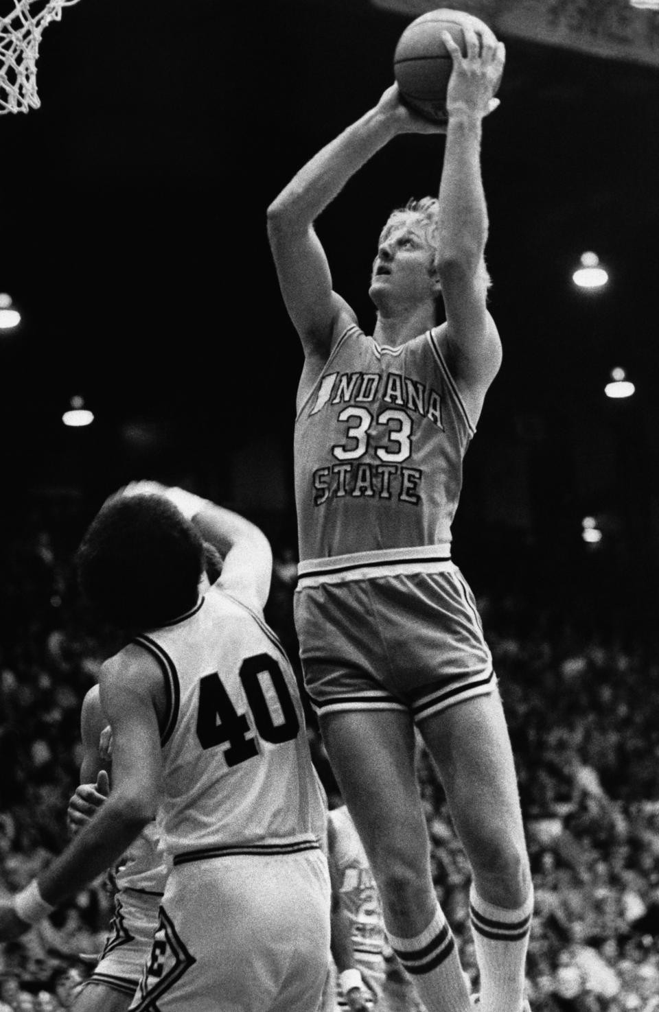 This Dec. 2, 1978 file photo shows Indiana State University basketball player Larry Bird (33) going up to score over University of Evansville's Barry Weston (40) in Evansville, Ind. The Indiana Pacers have parted ways with Bird. The 55-year-old Bird was the Pacers coach from 1997-2000, taking the team to its only NBA Finals appearance that final year, before returning to the front office in 2003. (AP Photo/File)