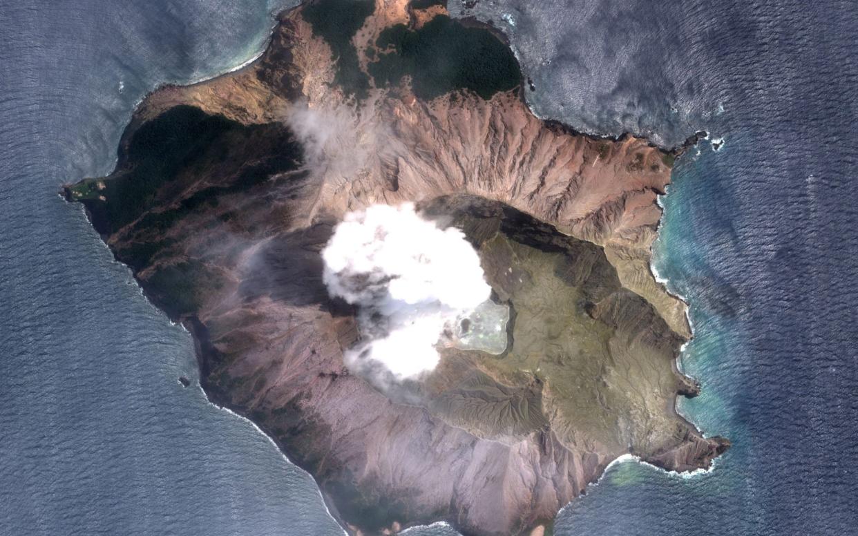 A handout satellite photo made available by MAXAR Technologies shows the White Island (Whakaari) volcano one day after erupting, in New Zealand - REX