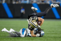 New Orleans Saints tight end Foster Moreau is tackled by Carolina Panthers cornerback Donte Jackson during the first half of an NFL football game Monday, Sept. 18, 2023, in Charlotte, N.C. (AP Photo/Jacob Kupferman)
