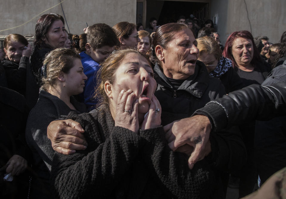 People attend the funeral of Said Abdel Ahad, a Christian fighter of the Syriac Military Council, in Hassakeh, Syria, Friday, Nov. 22, 2019. Ahad was killed in Turkish offensive near Tal Tamr. (AP Photo/Baderkhan Ahmad)