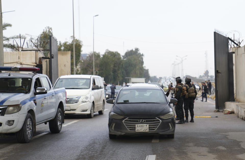 Iraqi security forces stand guard as they check motorists entering the Green Zone, in Baghdad, Iraq, Sunday, Jan. 8, 2023. (AP Photo/Hadi Mizban)