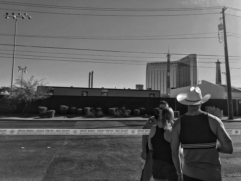 A couple speaks to a Las Vegas police officer guarding the perimeter of the Route 91 festival site Monday in Las Vegas. (Photo: Holly Bailey/Yahoo News)