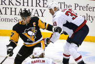 Pittsburgh Penguins' Sidney Crosby (87) is defended by Washington Capitals' Zdeno Chara (33) during the first period of an NHL hockey game in Pittsburgh, Tuesday, Jan. 19, 2021. (AP Photo/Gene J. Puskar)