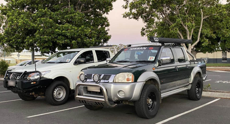 Mr Smith's green Nissan Navara and another white 4WD in a carpark. 