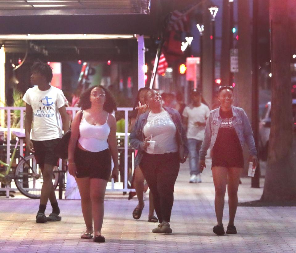 Crowds stroll along busy Seabreeze Boulevard on a Friday night in early June. After a quadruple-shooting this past weekend near Razzle's nightclub, neighborhood residents are calling for more to be done to curb late-night crime on the landmark thoroughfare in Daytona Beach.