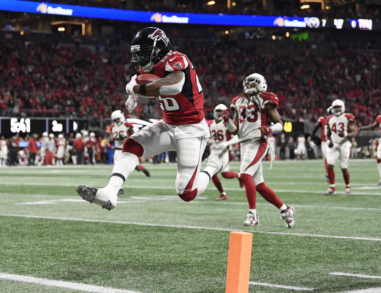 Atlanta Falcons running back Tevin Coleman (26) leaps into the end zone as he scores on a pass from Matt Ryan during the second half of an NFL football game against the Arizona Cardinals, Sunday, Dec. 16, 2018, in Atlanta. (AP Photo/Danny Karnik)