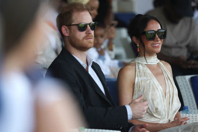 <p>KOLA SULAIMON/AFP via Getty</p> Prince Harry and Meghan Markle attend at a charity polo club in Lagos on May 12, 2024