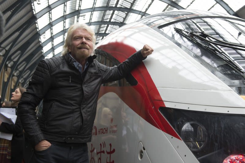 Virgin Group Founder Sir Richard Branson poses for photographs during the launch of a new fleet of trains for the Virgin Trains's East Coast Mainline route, at Kings Cross Station, London, Britain, in 2016. File Photo by Will Oliver/EPA