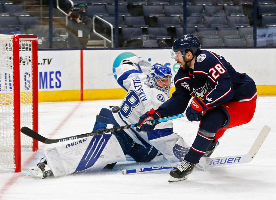 Columbus Blue Jackets right wing Oliver Bjorkstrand (28) shot is blocked by Tampa Bay Lightning goaltender Andrei Vasilevskiy (88) in the third period during their NHL game at Nationwide Arena in Columbus, Ohio on January 23, 2021. 