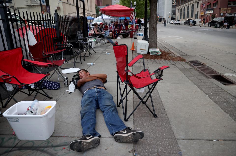 TULSA, OKLAHOMA - JUNE 19: Supporters of U.S. President Donald Trump sleep in the early morning while lined up to attend the campaign rally of U.S. President Donald Trump near the BOK Center, site of tomorrow's rally, June 19, 2020 in Tulsa, Oklahoma. Trump is scheduled to hold his first political rally since the start of the coronavirus pandemic at the BOK Center on Saturday while infection rates in the state of Oklahoma continue to rise.  (Photo by Win McNamee/Getty Images) ORG XMIT: 775525014 ORIG FILE ID: 1250658372
