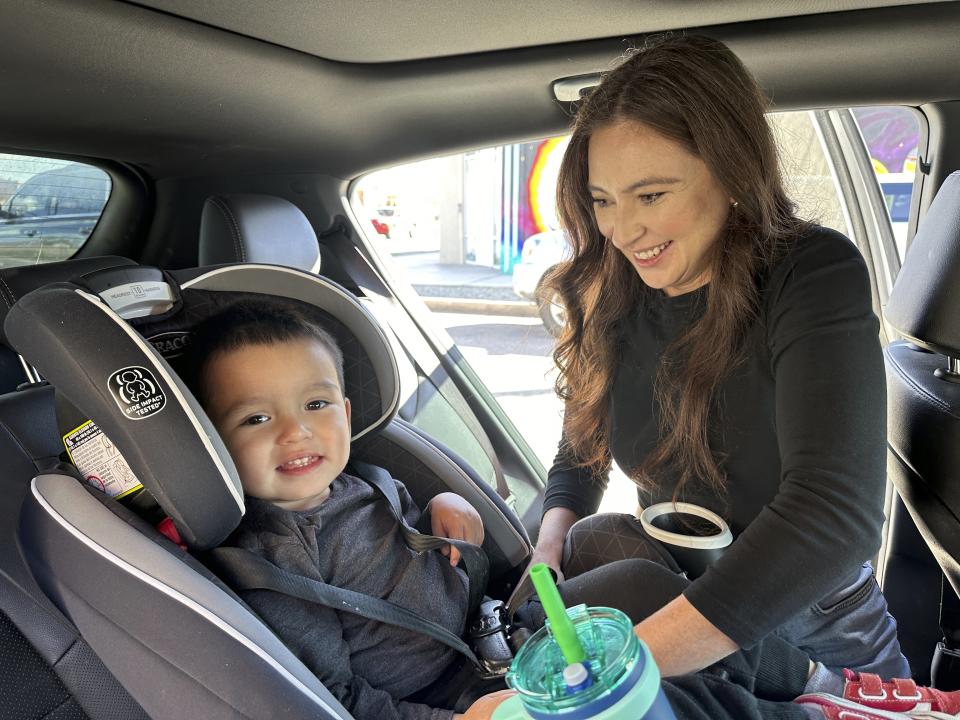Marisshia Sigala secures her son Mateo in his car seat after picking him up after work from the Koala Children's Academy in Albuquerque, New Mexico, on Wednesday, March 20, 2024. Like most other New Mexico families, Sigala and her husband qualify for subsidized child care in New Mexico, providing them more flexibility to see more clients as they build their careers. (AP Photo/Susan Montoya Bryan)