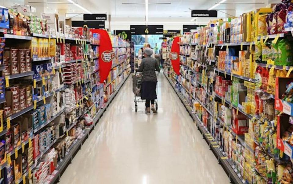 Woman shopping in supermarket aisle. Source: Getty Images