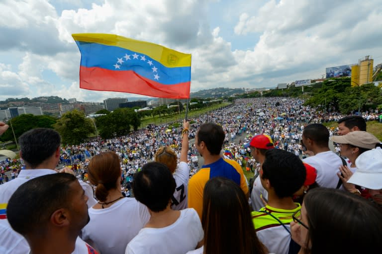 Lilian Tintori, wife of prominent jailed opposition leader Leopoldo Lopez, waves a Venezuelan national flag during a rally against the government of President Nicolas Maduro in Caracas