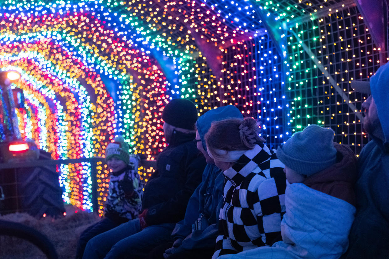 A family enjoys the lighted hayride trail at Maxwell's Magical Christmas in Amarillo.
