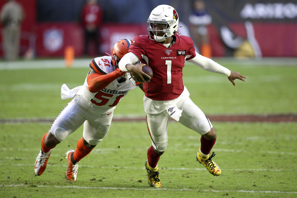 FILE - In this Dec. 15, 2019, file photo, Arizona Cardinals quarterback Kyler Murray (1) gets away from Cleveland Browns linebacker Mack Wilson (51) during the second half of an NFL football game in Glendale, Ariz. Coach Kliff Kingsbury and the Cardinals went 5-10-1 last year, but they're a popular pick to improve sharply this year. (AP Photo/Ross D. Franklin, File)