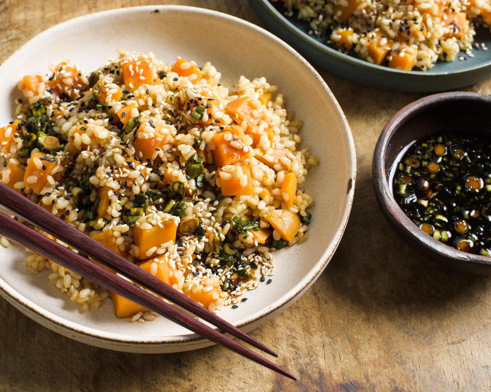 This image released by Milk Street shows a recipe for sweet potato brown rice with soy and scallions. (Milk Street via AP)