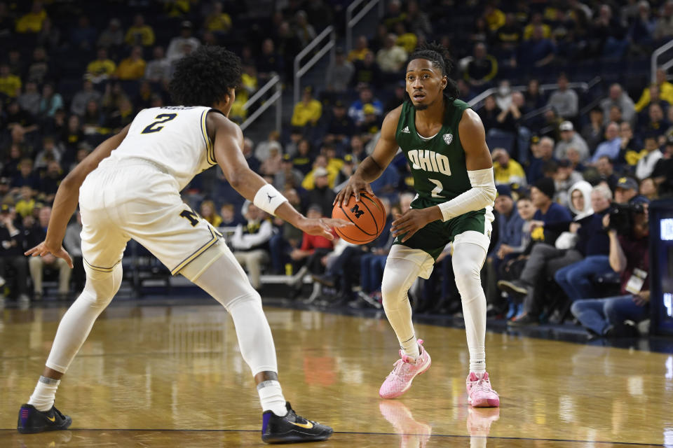 Ohio guard Miles Brown, right, dribbles against Michigan guard Kobe Bufkin in the first half of an NCAA college basketball game, Sunday, Nov. 20, 2022, in Ann Arbor, Mich. (AP Photo/Jose Juarez)