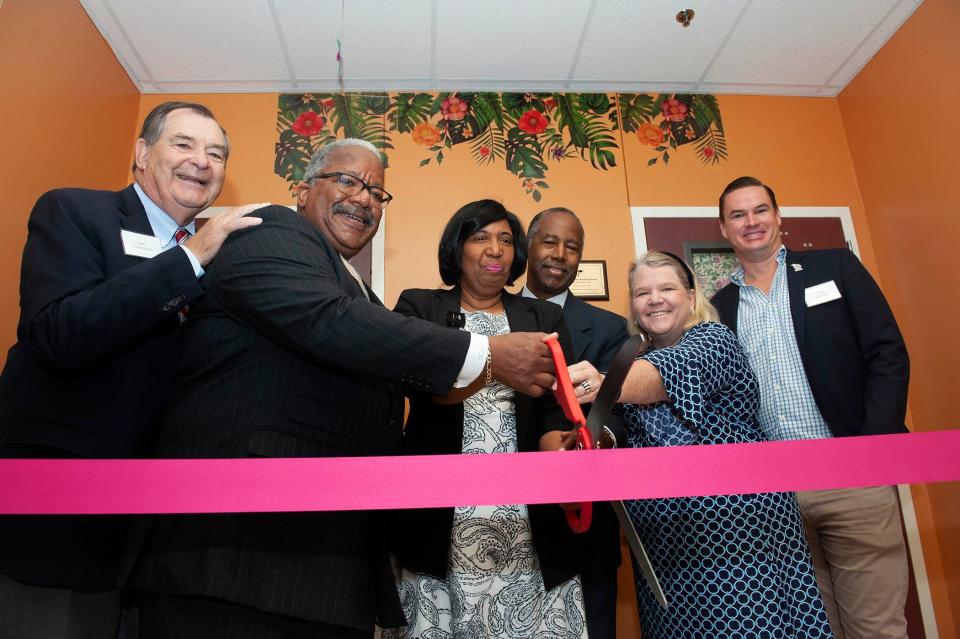 Palm Beach town Councilman Lew Crampton, West Palm Mayor Keith James, Candy and Dr. Ben Carson, Palm Beach Mayor Danielle Moore and Councilman Ted Cooney attend the Oct. 6, Ben Carson Reading Room ribbon-cutting ceremony at Palm Beach Public elementary school.