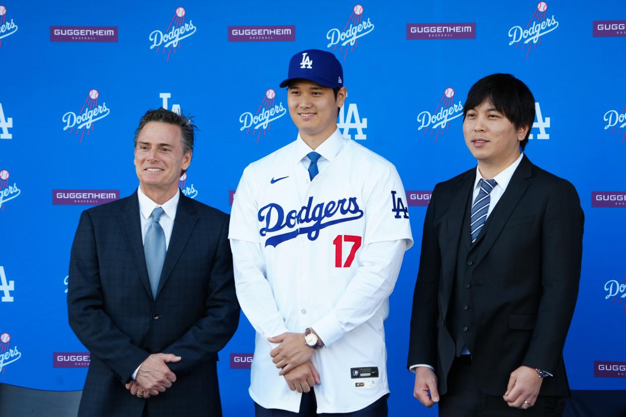 Shohei Ohtani stands next to interpreter Ippei Mizuhara at an introductory press conference at Dodger Stadium.
