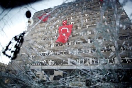 The Ankara police headquarters is seen through a car's broken window caused by fighting during a coup attempt in Ankara, Turkey, July 19, 2016. REUTERS/Baz Ratner/Files