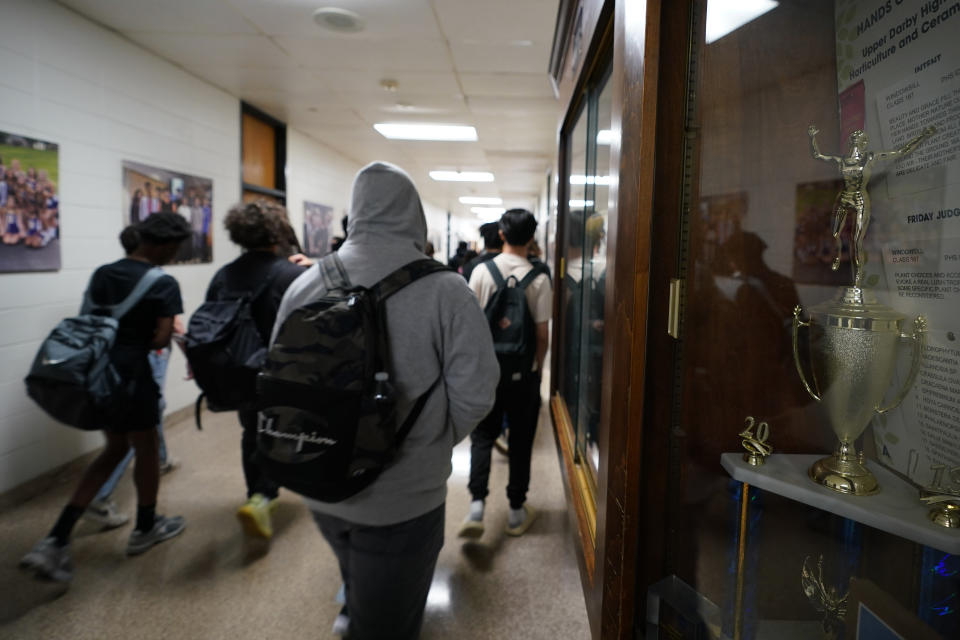 Students walk through Upper Darby High School, Wednesday, April 12, 2023, in Drexel Hill, Pa. For some schools, the pandemic allowed experimentation to try new schedules. Large school systems including Denver, Philadelphia and Anchorage, Alaska, have been looking into later start times.(AP Photo/Matt Slocum)