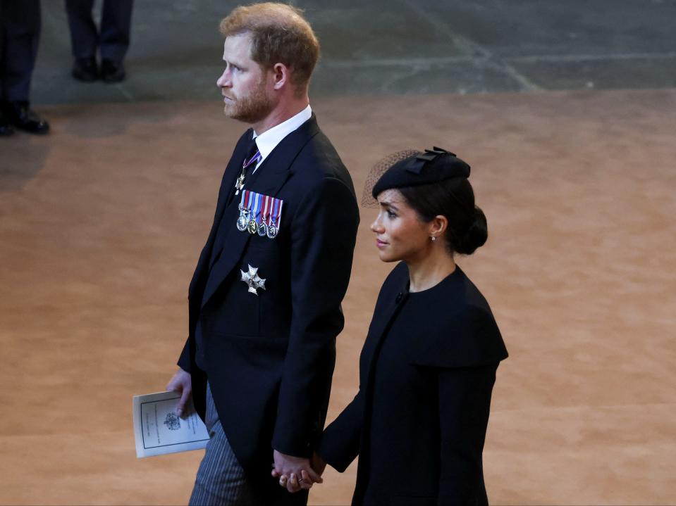 File Prince Harry and Meghan, Duchess of Sussex walk as procession with the coffin of Britain's Queen Elizabeth arrives at Westminster Hall (Getty Images)
