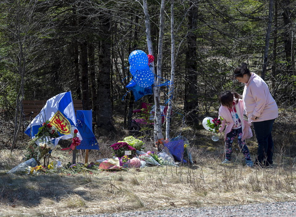 A memorial pays tribute to Heather O’Brien, a victim of this past weekend shootings along the highway in Debert, Nova Scotia, on Tuesday, April 21, 2020. RCMP say several people are dead after a man who at one point wore a police uniform and drove a mock-up cruiser, went a murder rampage in Portapique, and other Nova Scotia communities. The alleged killer was shot and killed by police. (Andrew Vaughan/The Canadian Press via AP)