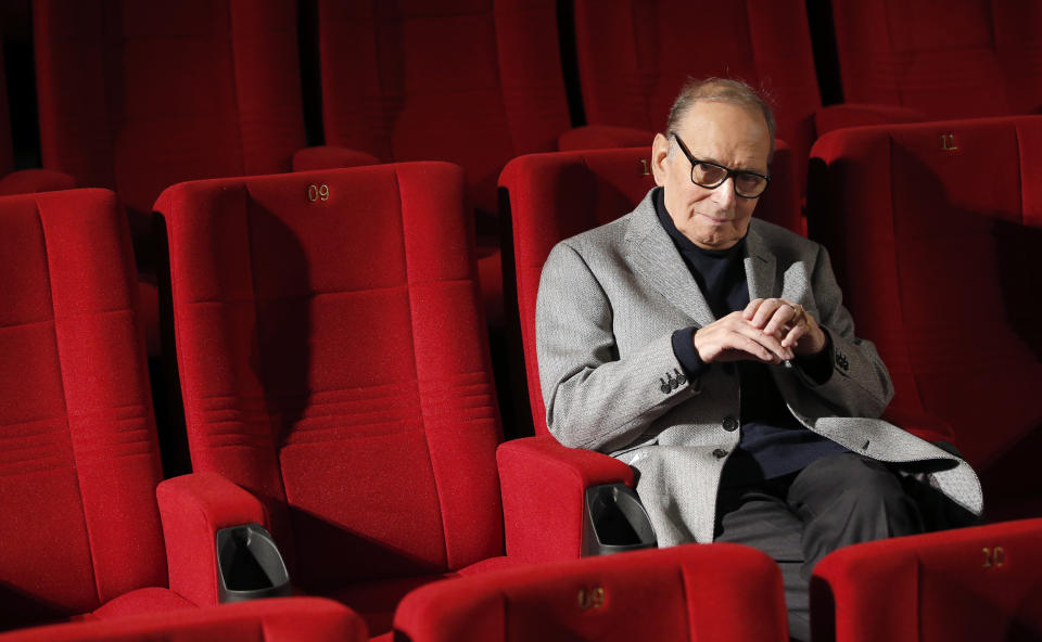 FILE - In this Dec. 6, 2013 file photo, Italian composer Ennio Morricone poses during a photo call to promote his German 2014 concerts, in Berlin, Germany. Morricone, who created the coyote-howl theme for the iconic Spaghetti Western “The Good, the Bad and the Ugly” and the soundtracks such classic Hollywood gangster movies as “The Untouchables,” died Monday, July 6, 2020 in a Rome hospital at the age of 91. (AP Photo/Michael Sohn, file)