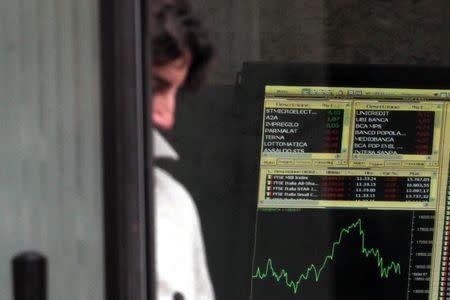 Man walks out Milan's stock exchange building in downtown Milan March 18, 2013. REUTERS/Alessandro Garofalo