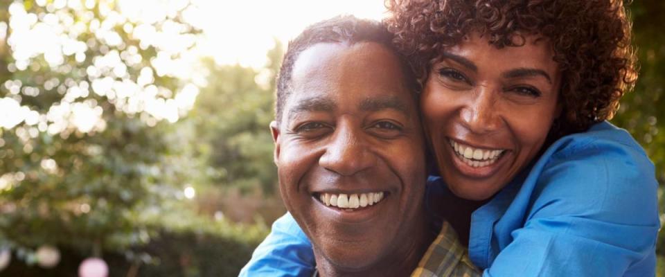 Portrait Of Loving Mature Couple In Back Yard Garden