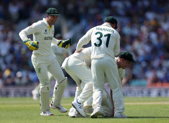 Cameron Green, right, celebrates catching India’s Shubman Gill off the bowling of Scott Boland