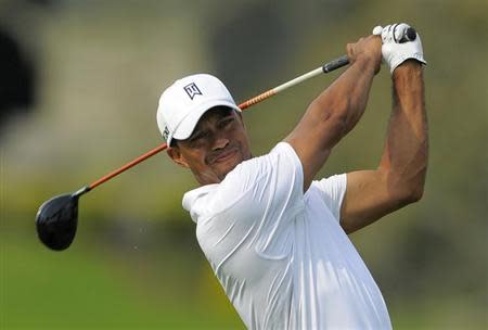 Tiger Woods watches his tee shot on the 16th hole during third round play in the Arnold Palmer Invitational PGA golf tournament in Orlando, Florida March 23, 2013. REUTERS/Scott Miller