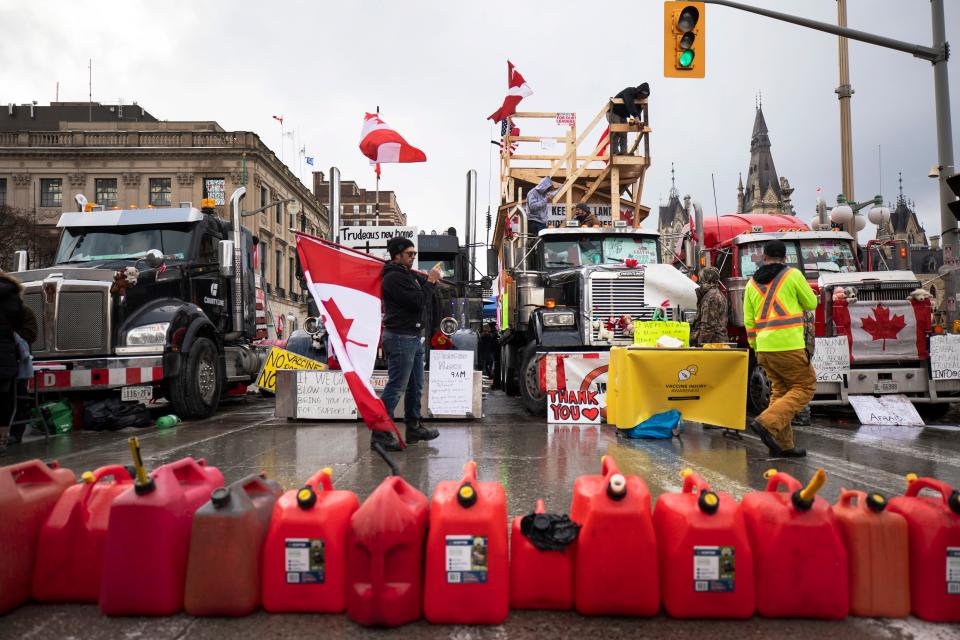 Protestors gather along Wellington Street as a protest against COVID-19 restrictions that have been marked by gridlock and the sound of truck horns reaches its 14th day, in Ottawa, Feb. 10, 2022.