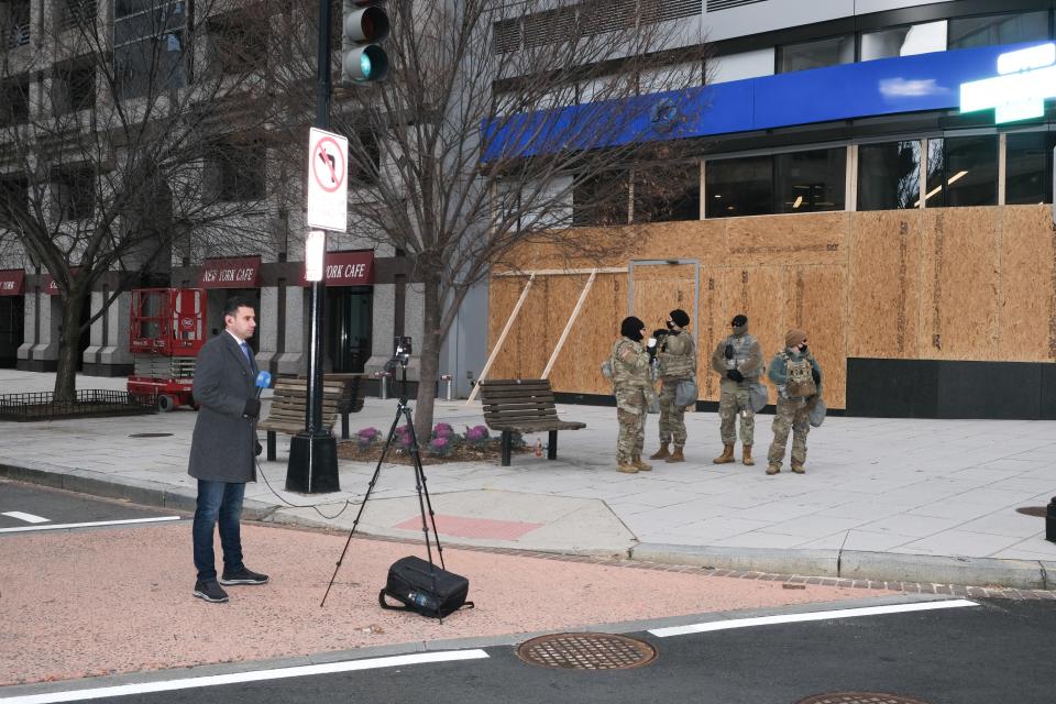 A journalist livestreams next to 4 of the 25,000 National Guard members in D.C. during the inauguration.