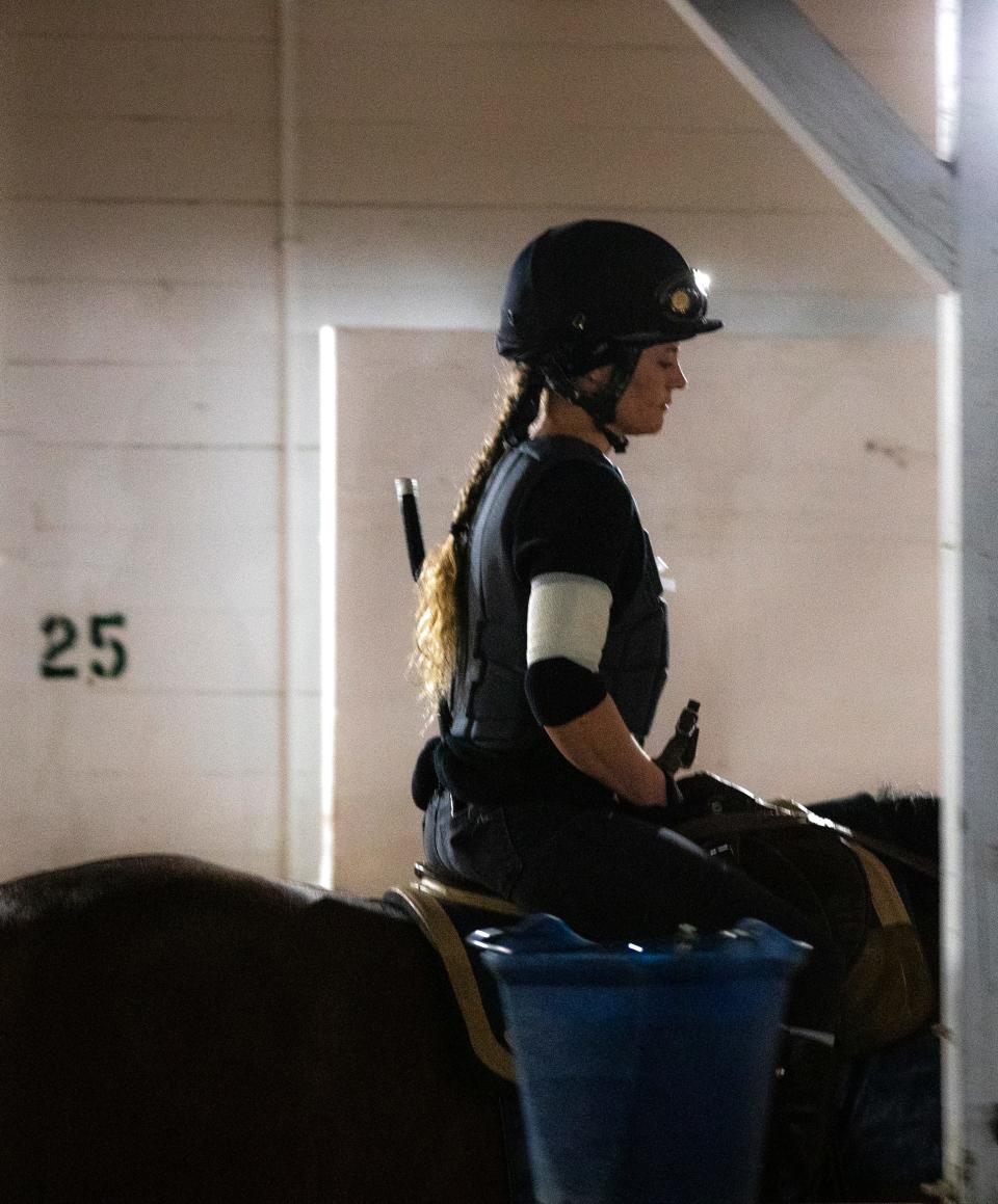 Exercise rider Hannah Sandwick at Churchill Downs wore a white arm band in honor of the late Callie Witt, a rider who died recently at Keeneland. May 5, 2022