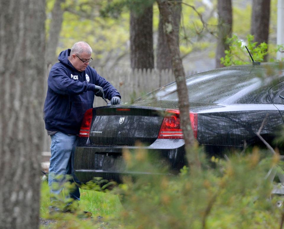 Armed with a warrant local, regional and federal officers searched 133 Azalea Drive on May 19. Merrily Cassidy/Cape Cod Times