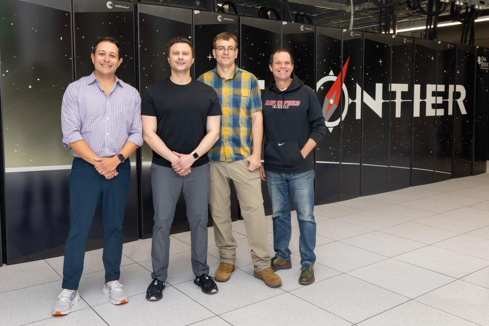 (From left to right) Atomic Canyon co-founders Trey Lauderdale and Kristian Kielhofner, Atomic Canyon Lead AI Architect Richard Klafter, and ORNL Research Scientist Tom Evans pose in front of Frontier.