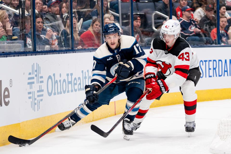 Dec 16, 2023; Columbus, Ohio, USA;
Columbus Blue Jackets right wing Justin Danforth (17) looks for an open pass against New Jersey Devils defenseman Luke Hughes (43) during the third period of their game on Saturday, Dec. 16, 2023 at Nationwide Arena.