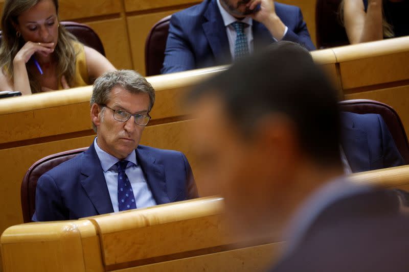 FILE PHOTO: Spain's opposition People's Party (PP) leader Feijoo listens to Spain's PM Sanchez speak during a session at the Spanish Senate in Madrid