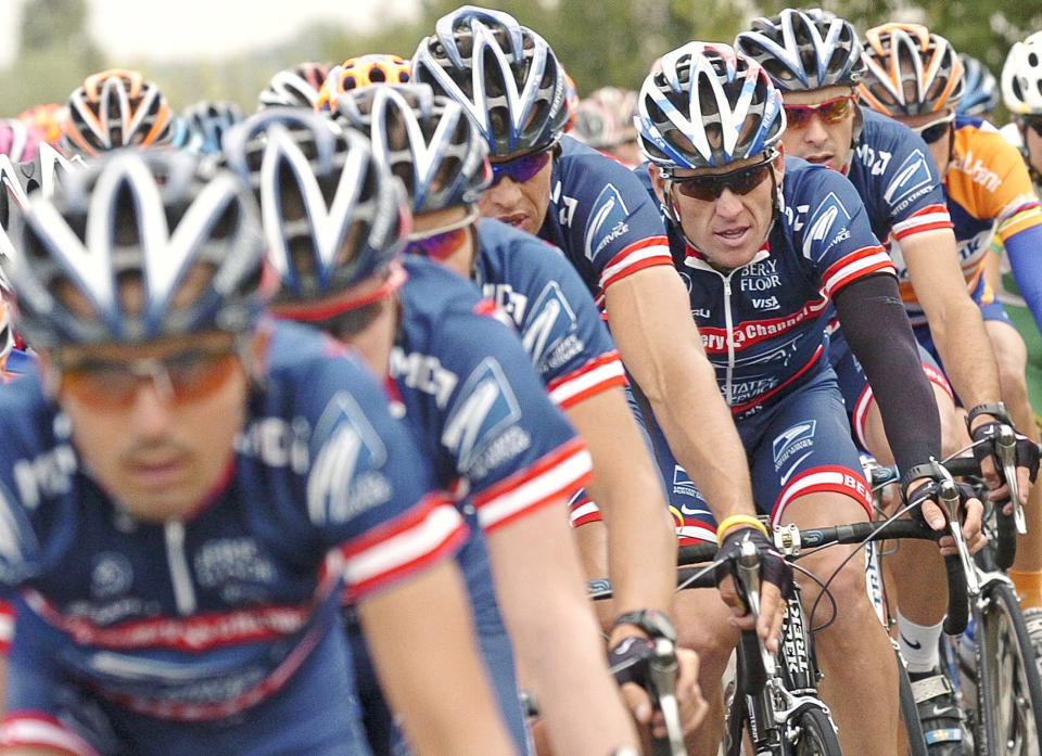 This July 5, 2004 file photo shows U.S. Postal Service team leader and five-time Tour de France winner Lance Armstrong, third from right, framed by his teammates as the pack rides during the second stage of the 91st Tour de France cycling race between Charleroi and Namur, Belgium. 