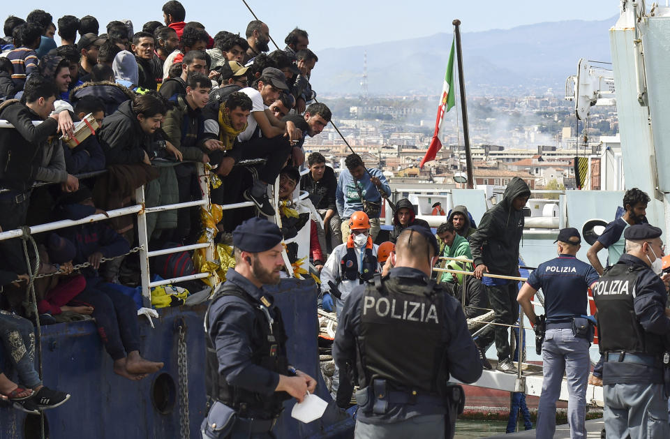 FILE - Migrants disembark from a ship in the Sicilian port of Catania, April 12, 2023. Some 110 million people around the world have had to flee their homes because of conflict, persecution, or human rights violations, the U.N. High Commissioner for Refugees says. (AP Photo/Salvatore Cavalli, File)