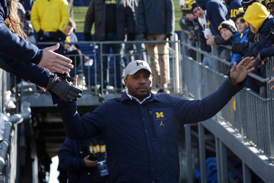 Michigan offensive coordinator Josh Gattis high-fives fans before the Michigan State game at Michigan Stadium in Ann Arbor, Saturday, Nov. 16, 2019.