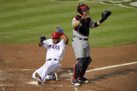 ARLINGTON, TX - OCTOBER 23: Elvis Andrus #1 of the Texas Rangers scores in the first inning after a Josh Hamilton #32 RBI double in front of Yadier Molina #4 of the St. Louis Cardinals during Game Four of the MLB World Series at Rangers Ballpark in Arlington on October 23, 2011 in Arlington, Texas. (Photo by Doug Pensinger/Getty Images)