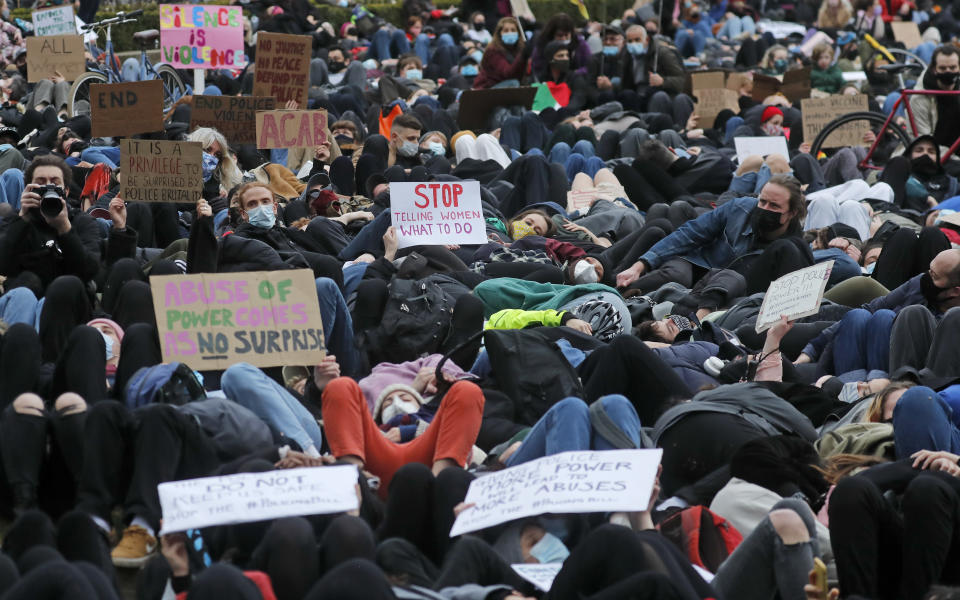 Demonstrators lay-down in Parliament Square in London, Sunday, March 14, 2021 during a protest over the abduction and murder of Sarah Everard and the subsequent handling by the police of a vigil honoring the victim. London's Metropolitan Police force was under heavy pressure Sunday to explain its actions during a vigil for Sarah Everard whom one of the force's own officers is accused of murdering. (AP Photo/Frank Augstein)