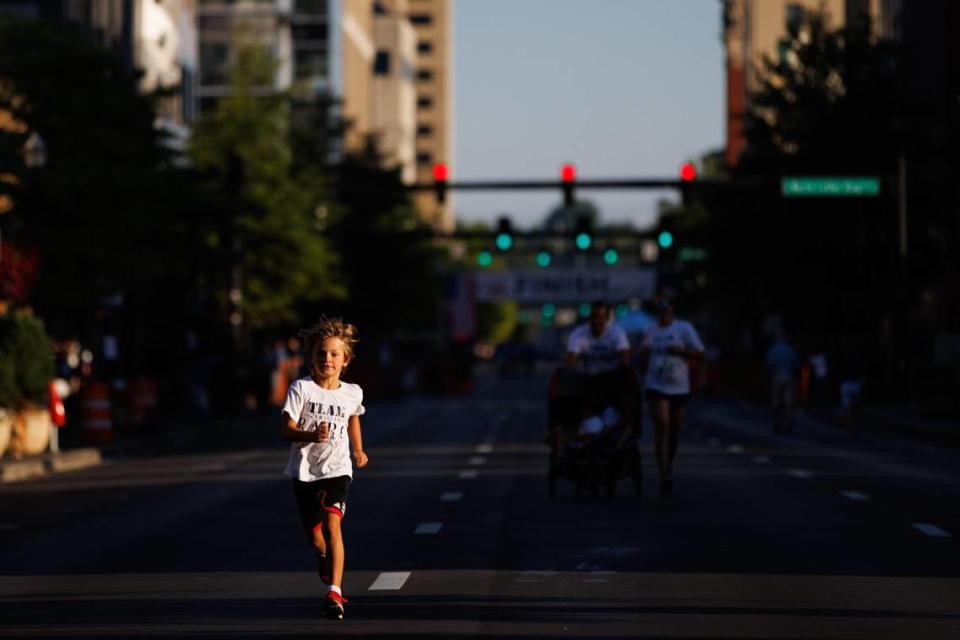 Conrad Blanchett, 7, runs ahead of the rest of his family during the Bluegrass 10,000.