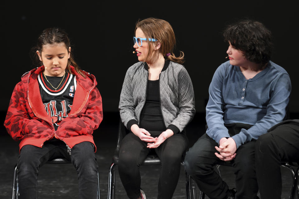 From left; Andre Clarke, Ember Bradley and Oliver Baez perform in a scene from “The Bullying Collection” at Wheatland High School in Wheatland, Wyoming on Friday, Jan. 12, 2024. School officials canceled the middle school play in part because it mentioned a gay character. The anti-bullying play was nonetheless performed under private sponsorship. (AP Photo/Thomas Peipert)