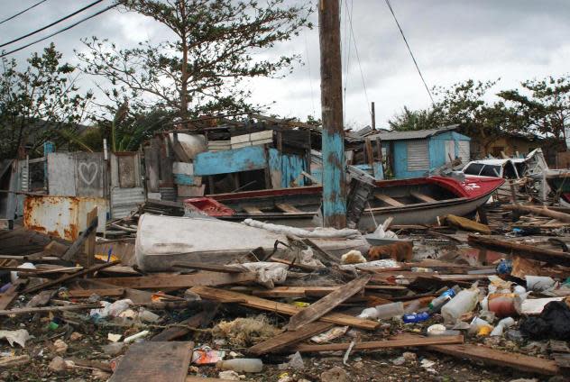 Debris left by Hurricane Dean is seen 20 August 2007 in Kingston, Jamaica. Hurricane Dean crept into the northwestern Caribbean Sea early Monday after unleashing its fury on Jamaica, prompting its government to declare a state of emergency. The category four hurricane was whipping up giant surf and dumping inches of rain on the island. Roads were blocked by fallen trees and flooded in the eastern parts of the island, with power cuts affecting thousands of homes. (Photo by Anthony A FOSTER / AFP) (Photo by ANTHONY A FOSTER/AFP via Getty Images)