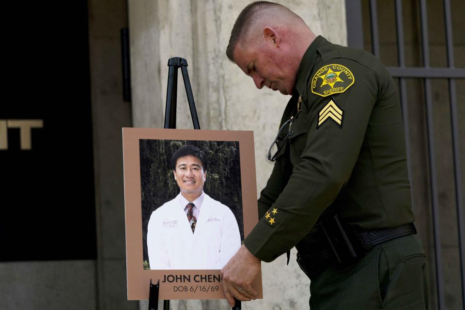 FILE - Orange County Sheriff's Sgt. Scott Steinle displays a photo of Dr. John Cheng, a 52-year-old victim who was killed in Sunday's shooting at Geneva Presbyterian Church, during a news conference in Santa Ana, Calif., on May 16, 2022. Officials in California's Orange County are still trying to determine why a gunman opened fire in the Taiwanese Presbyterian church in Laguna Woods. (AP Photo/Jae C. Hong, File)