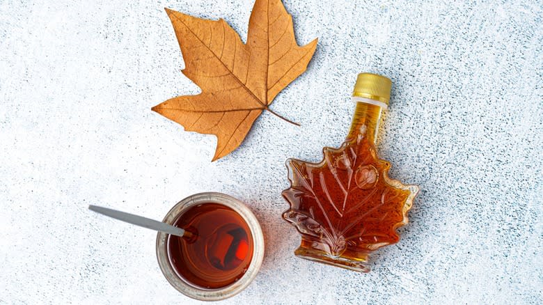 Maple syrup in a dish and maple leaf bottle