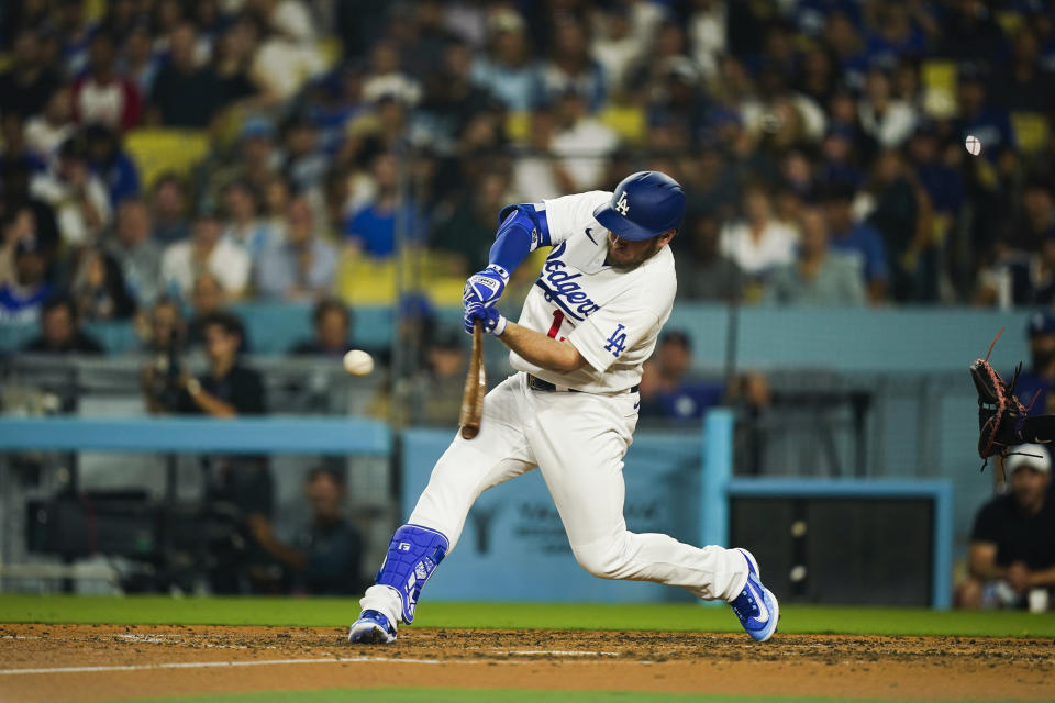 Los Angeles Dodgers designated hitter Max Muncy hits a homer during the seventh inning of a baseball game against the Colorado Rockies, Thursday, Aug. 10, 2023, in Los Angeles. (AP Photo/Ryan Sun)